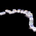 Domino stones symbolizing the steps of expat life in Germany, including services, finance consulting, and real estate